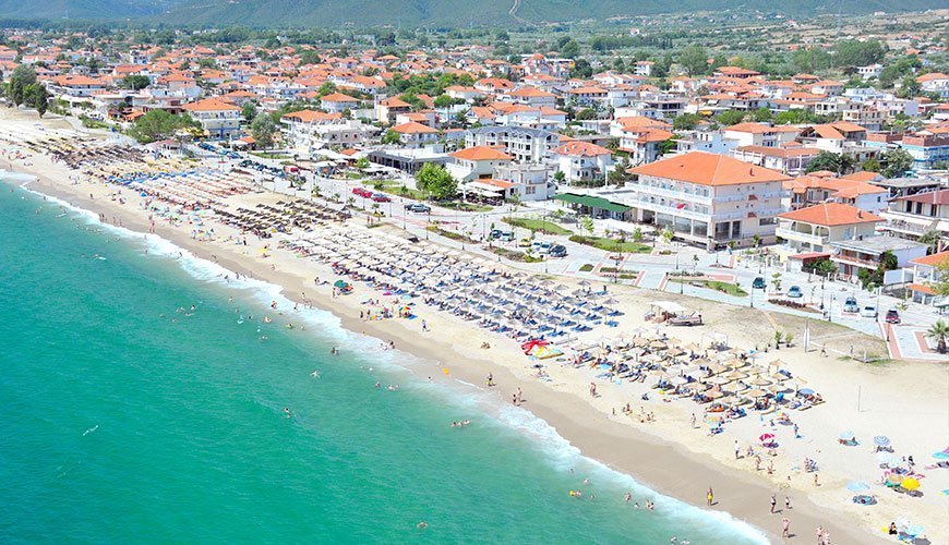 Aerial view of Asprovalta beach, turquoise sea and the village along the promenade