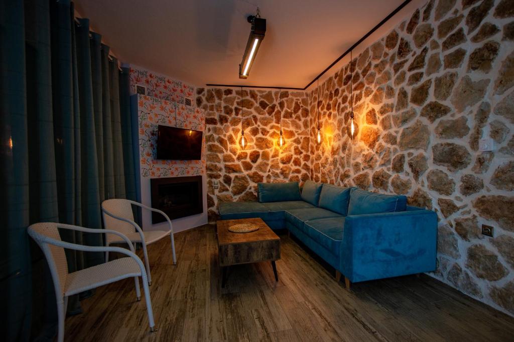 Blue corner sofa in the stone-walled living area